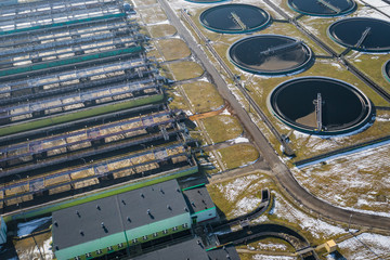 Sewage farm. Static aerial photo looking down onto the clarifying tanks. Industrial place. Geometric background texture. Photo captured with drone.