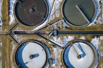 Sewage farm. Static aerial photo looking down onto the clarifying tanks. Industrial place. Geometric background texture. Photo captured with drone.