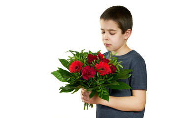 Cute boy looking at bouquet of red flowers, isolated on white