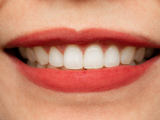 Obraz premium Closeup shot of human Asian Chinese Thai woman female makeup face. Woman with red lips lipstick and healthy dental white great perfect teeth. Smiling, Dental dentist clinic concept.