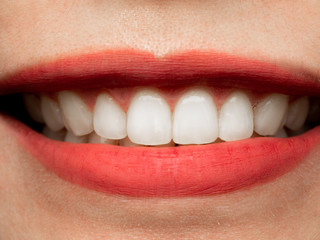 Closeup shot of human Asian Chinese Thai woman female makeup face. Woman with red lips lipstick and healthy dental white great perfect teeth. Smiling, Dental dentist clinic concept.
