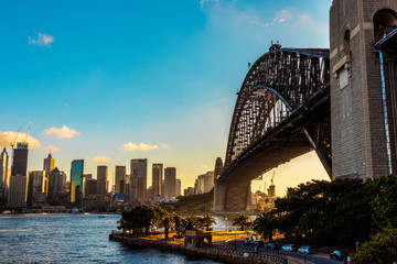 A beautiful view on the harbour bridge in sydney with the skyline and a clear blue sky