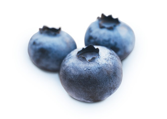 Blueberry. Three fresh blueberries with shadow isolated on white background. Closeup.