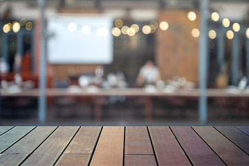 image of wooden table in front of abstract blurred background