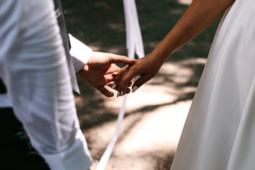 bride and groom holding hands