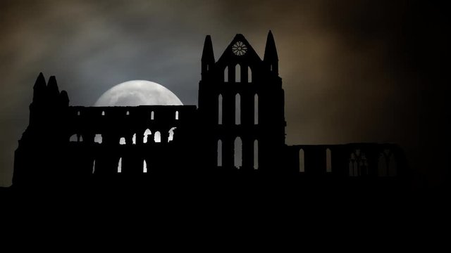 Whitby Abbey Castle by Night with Full Moon, a Ruined Benedictine monastery sited on Yorkshire, England UK. The Gothic church which Inspired Bram Stoker to write his most Famous Novel Dracula