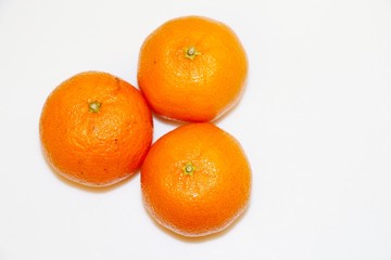 Three mandarins isolated on white background and space for your text.