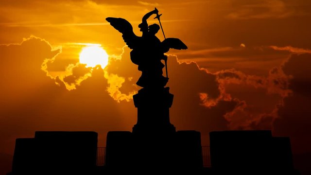 Rome: Bronze statue of Michael the Archangel at Sunset, standing on top of the Castel Sant'Angelo or Castle of the Holy Angel (Mausoleum of Hadrian), Italy, Europe