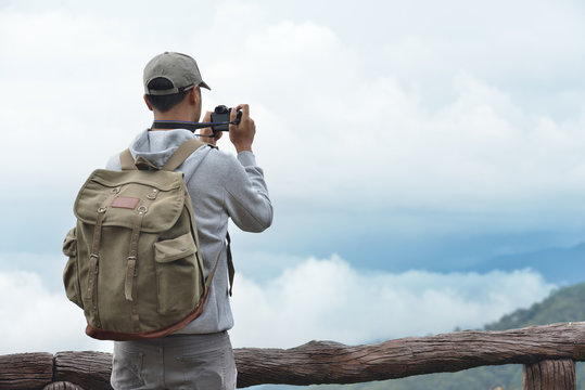 Young man travel photographer taking nature photo of mountain landscape  (Thailand )