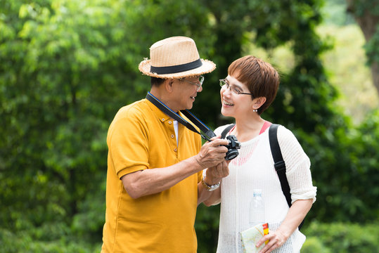Image of happy romantic Asian senior couple outdoor in park
