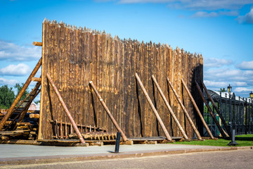 Medieval wooden fence made of palisade