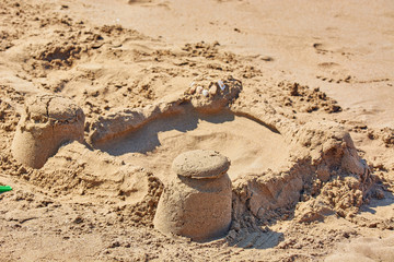 Sand castle made by childrens bucket on beach.