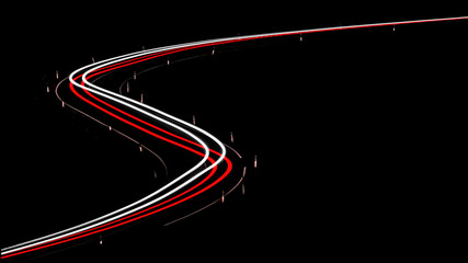 Light trail from cars driving an double bended curve in the night