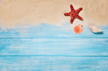 Fototapeta na wymiar Top view of sandy beach and marine blue planks pier. Background with copy space and visible sand and wood texture.