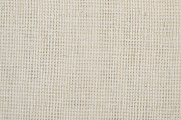 Fototapeta na wymiar texture of rough linen fabric beige color, closeup