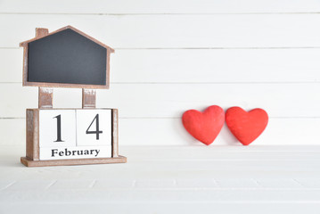 Valentines day concept, Happy Valentines Day, Valentines background. February 14 text wooden block calendar with two red hearts on white wooden background.