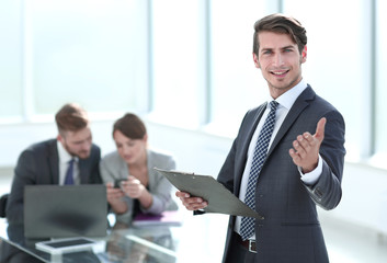 confident young businessman standing in the office.