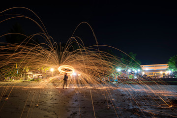 Amazing Fire dancing steel wool and lamp in the night.