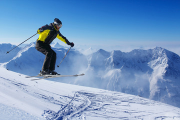 Fototapeta na wymiar Jumping skier at mountains