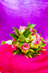 elegant bouquet of white and pink roses, pink eustoma with green leaves on a bright pink and violet background, a gift and a seduction