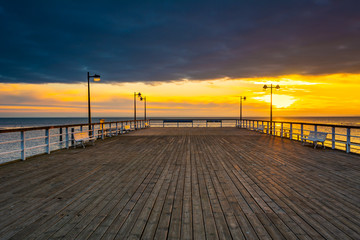 Wooden pier in Jastarnia village on Hel Peninsula at sunset time. Poland.