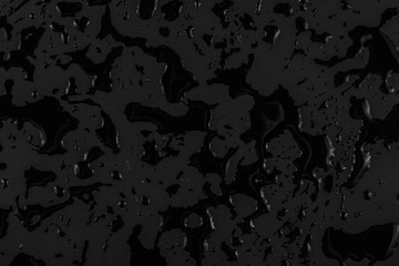 black liquid on a black background, abstract dark background, blots of different shapes
