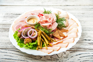 Sliced from bacon on a white plate. Rose from fat. Lard chopped with black bread, mustard, onion, close-up fermented food and copy space