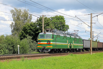 Naklejka premium electric locomotive with freight train