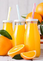 Glass bottles of raw organic fresh orange juice
