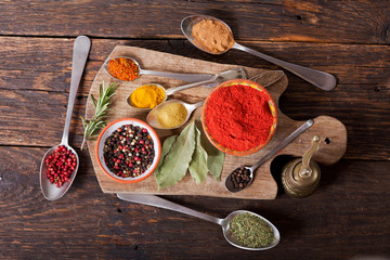 various herbs and spices for cooking on wooden board