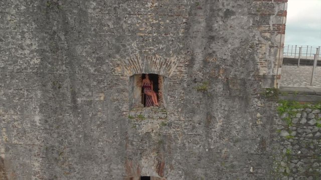 Aerial Backward: Sexy Woman Posing in Castle Window in Haiti