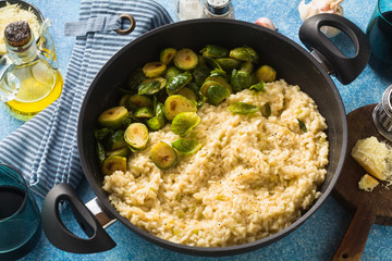 Italian spring risotto with Brussels sprouts and parmesan cheese on the table. healthy food for the whole family, party or restaurant menu
