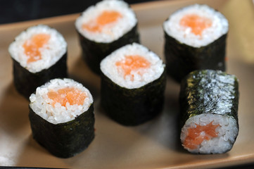 Classic roll with salmon. Rolls on a plate occupy the entire space of the frame. Ceramic light plate. Close-up. Macro shooting.