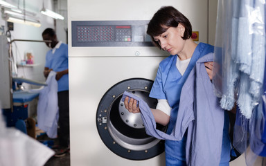 Female worker inspecting garments