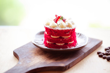 Delicious Red Velvet Layer Cake on burned wood. Home made Cake concept.
