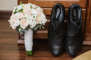 Grooms accessories for preparation on wedding day, shoes, rings and bouquet