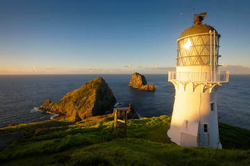 Sunset at historic lightouse at the end of Cape Brett Track, New Zealand