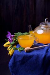 Orange sbiten in a glass cup. Traditional Russian drink with honey