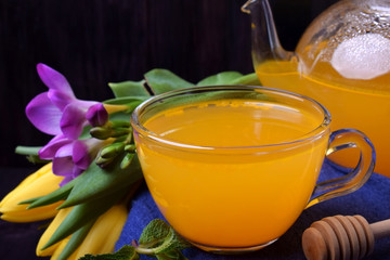 Orange sbiten in a glass cup. Traditional Russian drink with honey