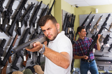 Men choosing air weapon