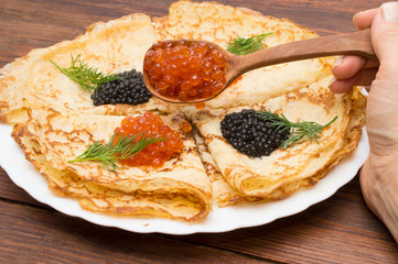traditional Russian crepes with black and red caviar.