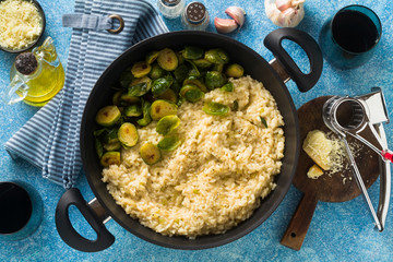 Italian spring risotto with Brussels sprouts and parmesan cheese on the table. healthy food for the whole family, party or restaurant menu