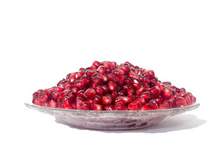 Pomegranate grains on a plate.  Isolated on white.