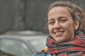 Beautiful attractive girl in a red checkered scarf