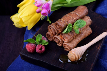 Chocolate rolled crepes topped with honey and mint