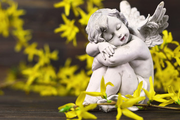 Angel and yellow spring flowers