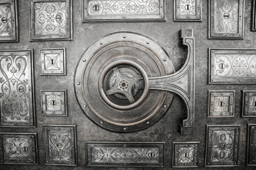 Bank safe (strongbox) vintage lock with wheel on the metal door
