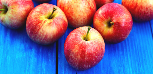 red apples on wooden background