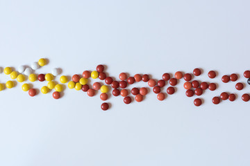 Way of colorful chocolate coated candy isolated on white background