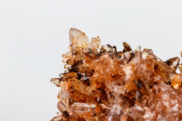 Macro of mineral stone Creedite on microcline on white background